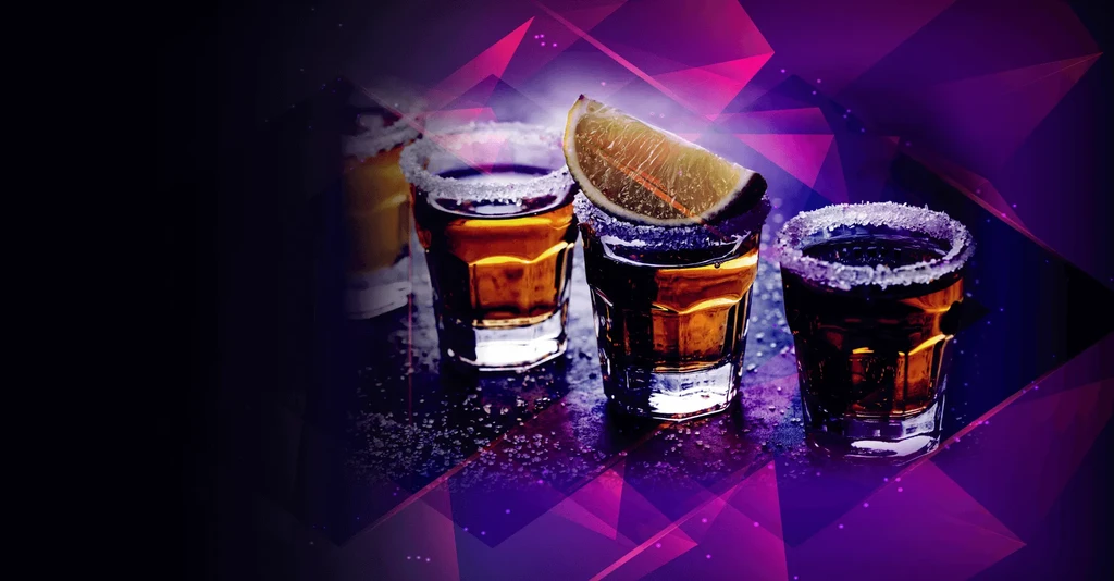 Three dark amber liquid shots with salt-rims and lime.