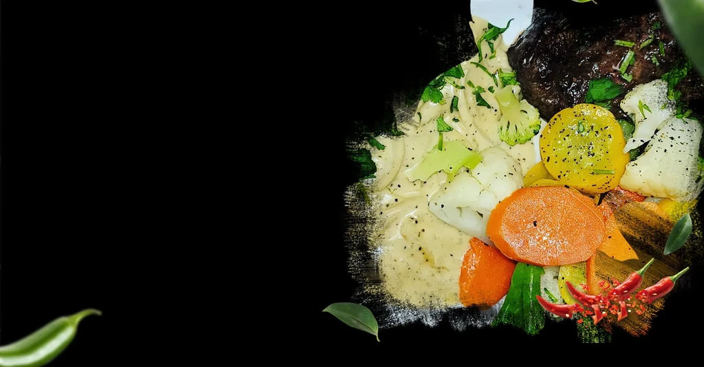 A plate of meat and vegetables with creamy sauce on a dark background.