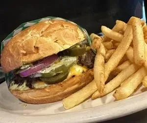 Hamburger with jalapeños, cheese, red onion, and a side of fries.
