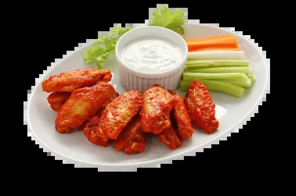 Plate of buffalo wings, dipping sauce, celery, and carrots.