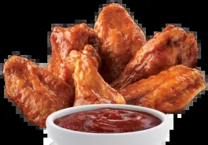 Fried chicken wings with reddish-orange sauce and a dipping bowl.