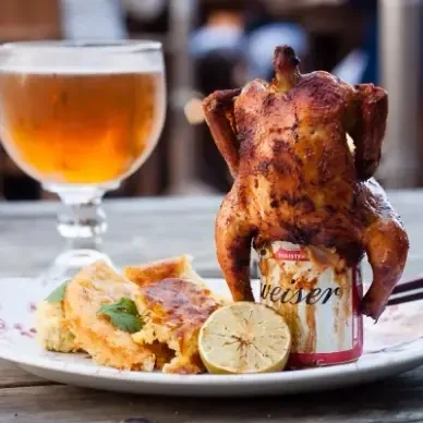 Roasted chicken on a beer can, cornbread, lime, and beer.