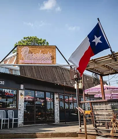 Exterior of "Preslee's Southern Good Eatery" with a Texas flag.