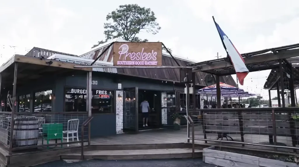 Exterior of Preslee's Southern Good Eatery with patio and umbrellas.