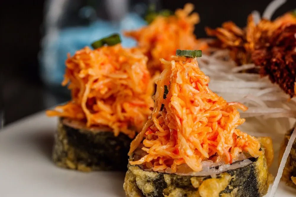 Sushi rolls topped with crab salad and spicy mayonnaise.