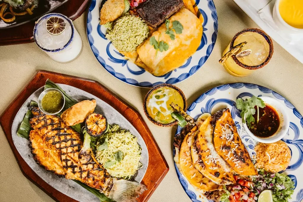 Overhead shot of a table with several plates of Mexican food.