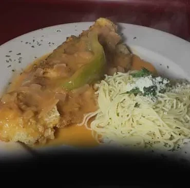 Breaded fish or chicken with sauce, spaghetti, and grated cheese.