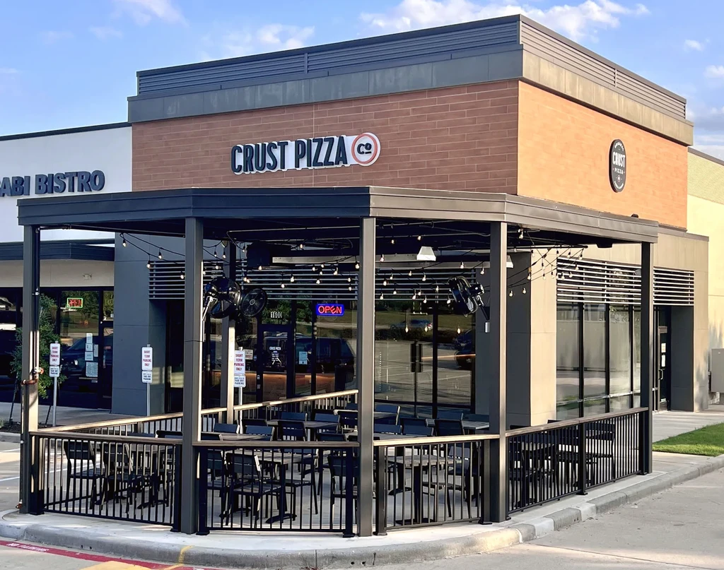 Exterior of Crust Pizza Co. with an outdoor patio.