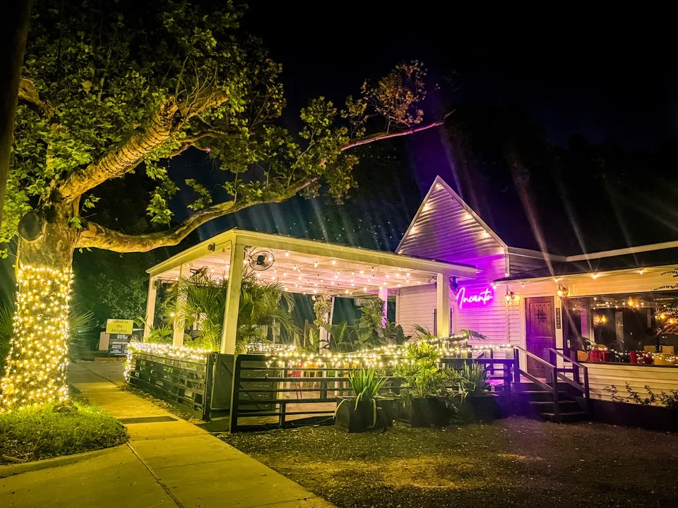 Restaurant Incanto exterior at night, with purple and white lights.