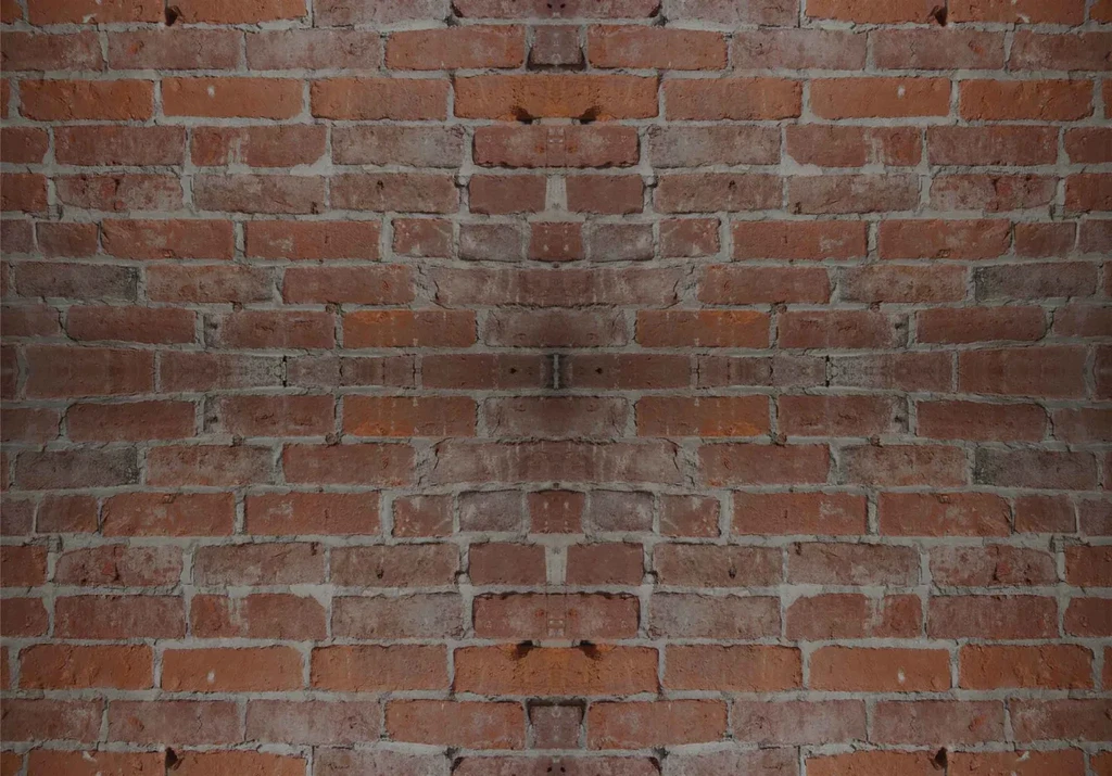 Aged, reddish-brown brick wall with rough texture and light grey mortar.