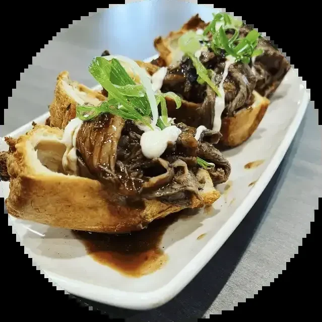 Three savory pastries filled with braised meat, white sauce, and herbs.