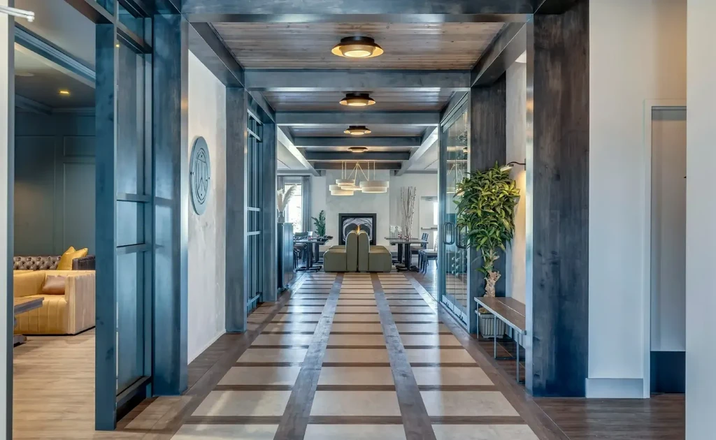 Modern restaurant hallway with patterned floor leading to a lounge.