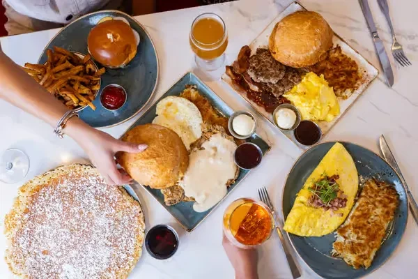 Overhead shot of a table laden with various breakfast and brunch dishes.