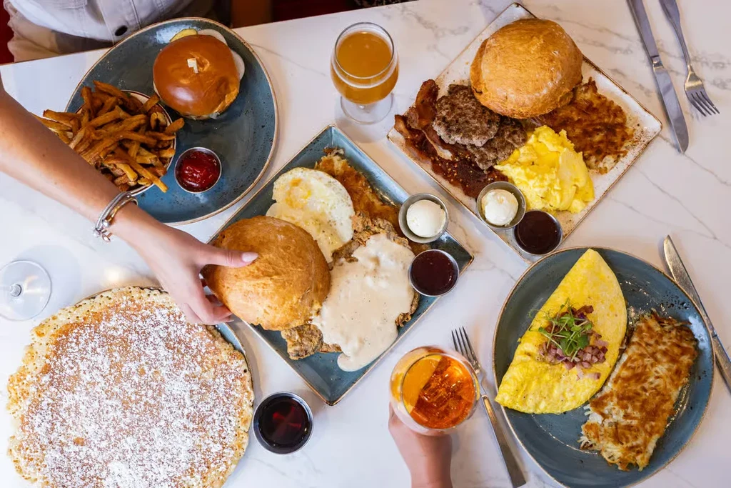 Overhead shot of a table laden with various breakfast and brunch dishes.