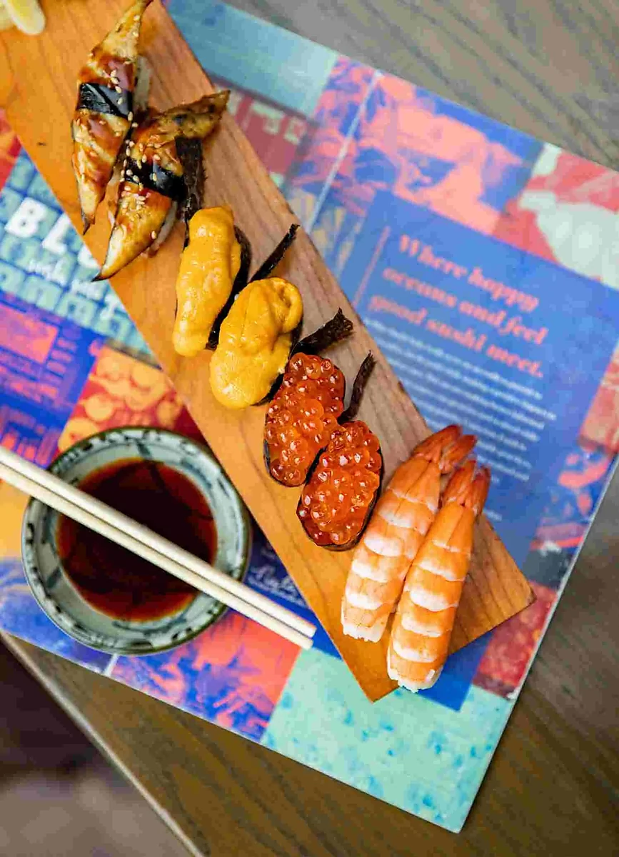 Wooden plank of eel, uni, ikura and shrimp nigiri