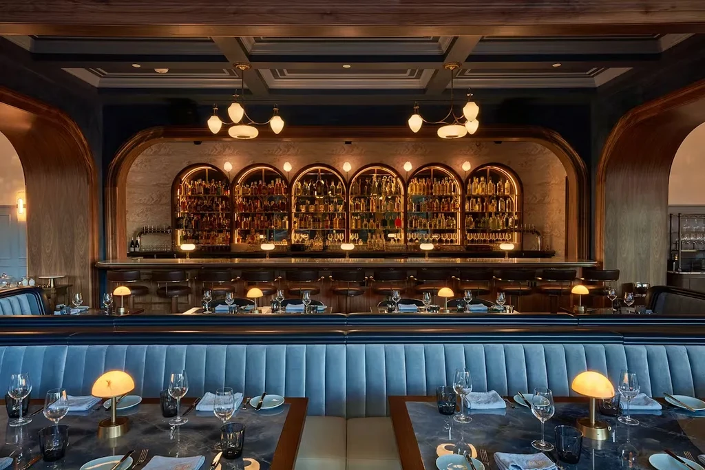 Elegant restaurant interior with a bar and dining tables.