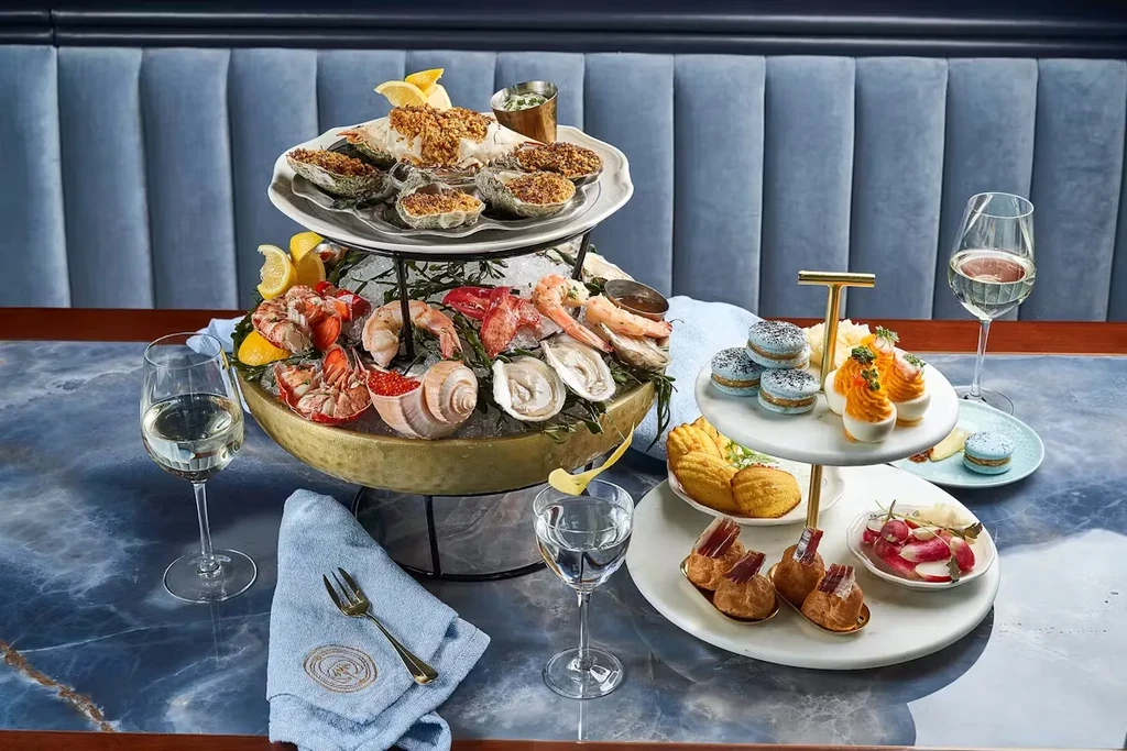 Luxurious seafood and appetizer spread on a marbled table.