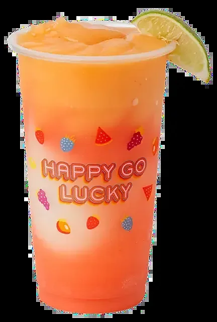 Orange frozen cocktail in tall cup garnished with lime wedge
