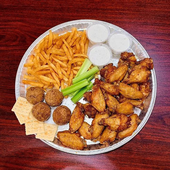 Platter of fried wings, fries, boudin balls, crackers and dressings