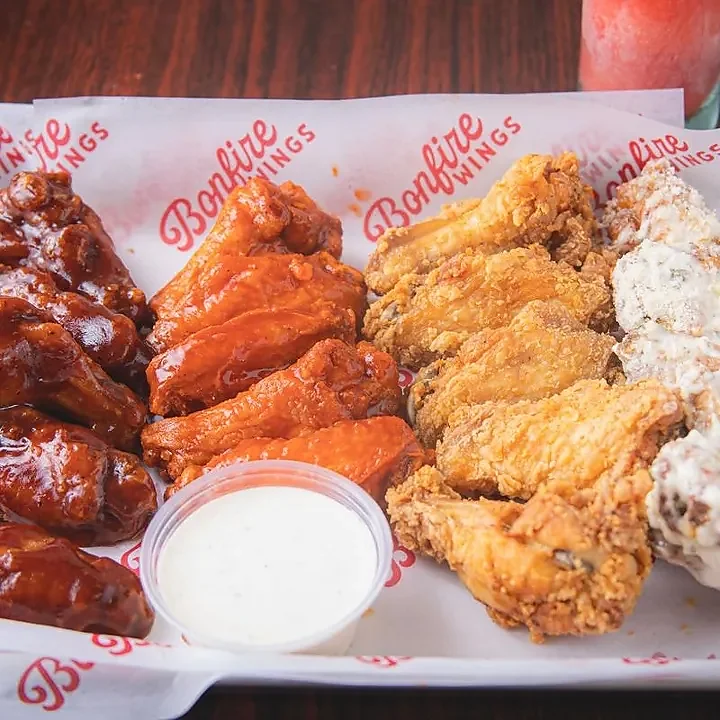 Basket of assorted wings with ranch dressing and frozen drink