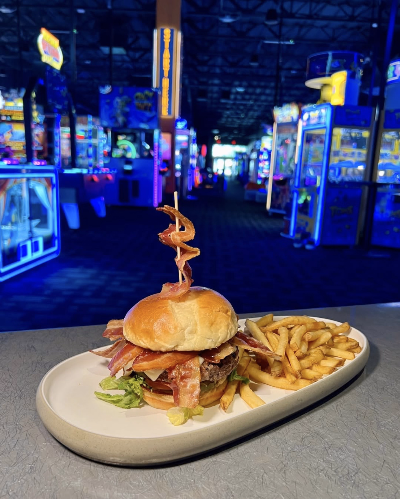 Gourmet bacon cheeseburger with cheddar cheese, crispy bacon strips, and fresh veggies.