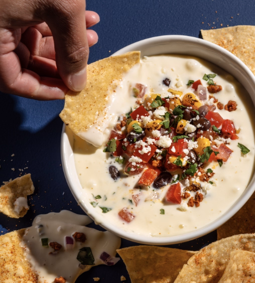 Warm, cheesy queso dip served with crispy tortilla chips.