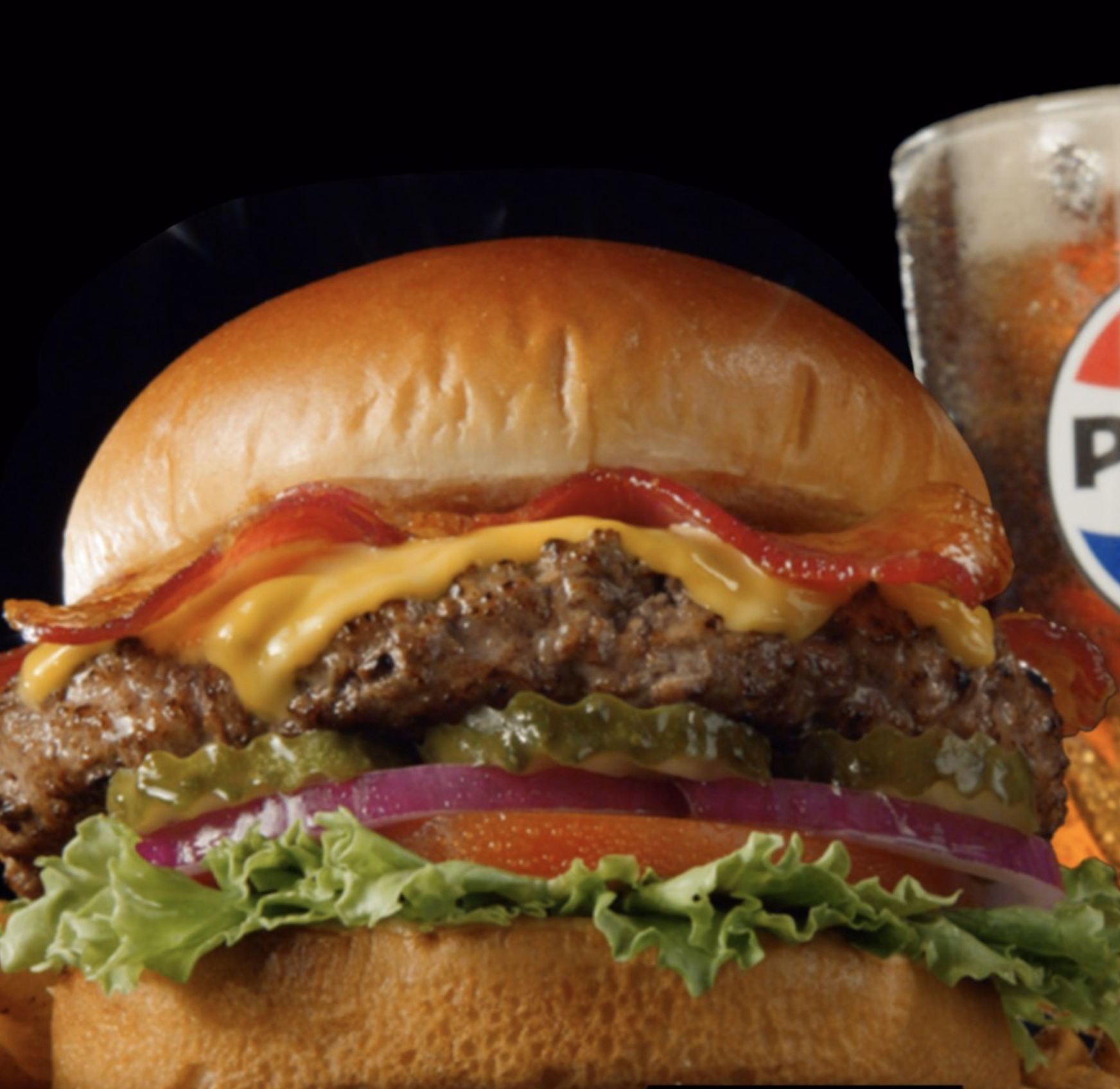 Juicy bacon cheeseburger with lettuce, tomato, pickles, and melted cheese.