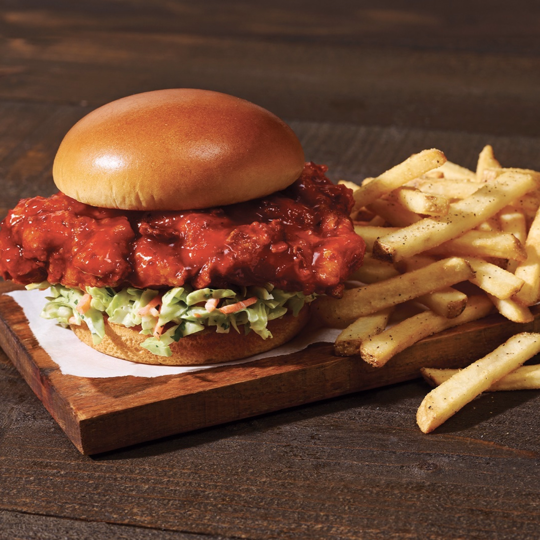 Zesty hot chicken sandwich with shredded slaw and crispy fries.