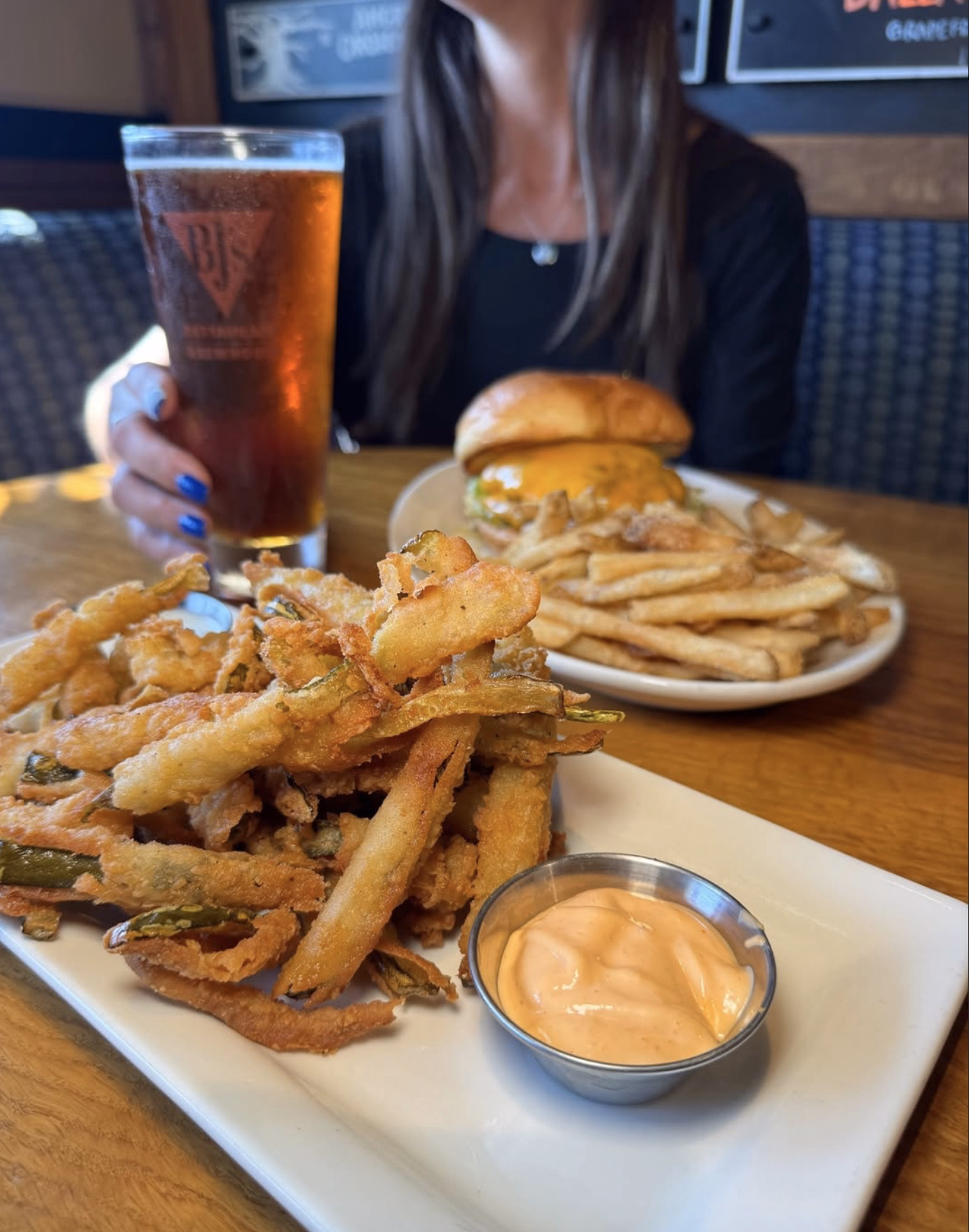 A spread of fried veggies, fries, and pickles.