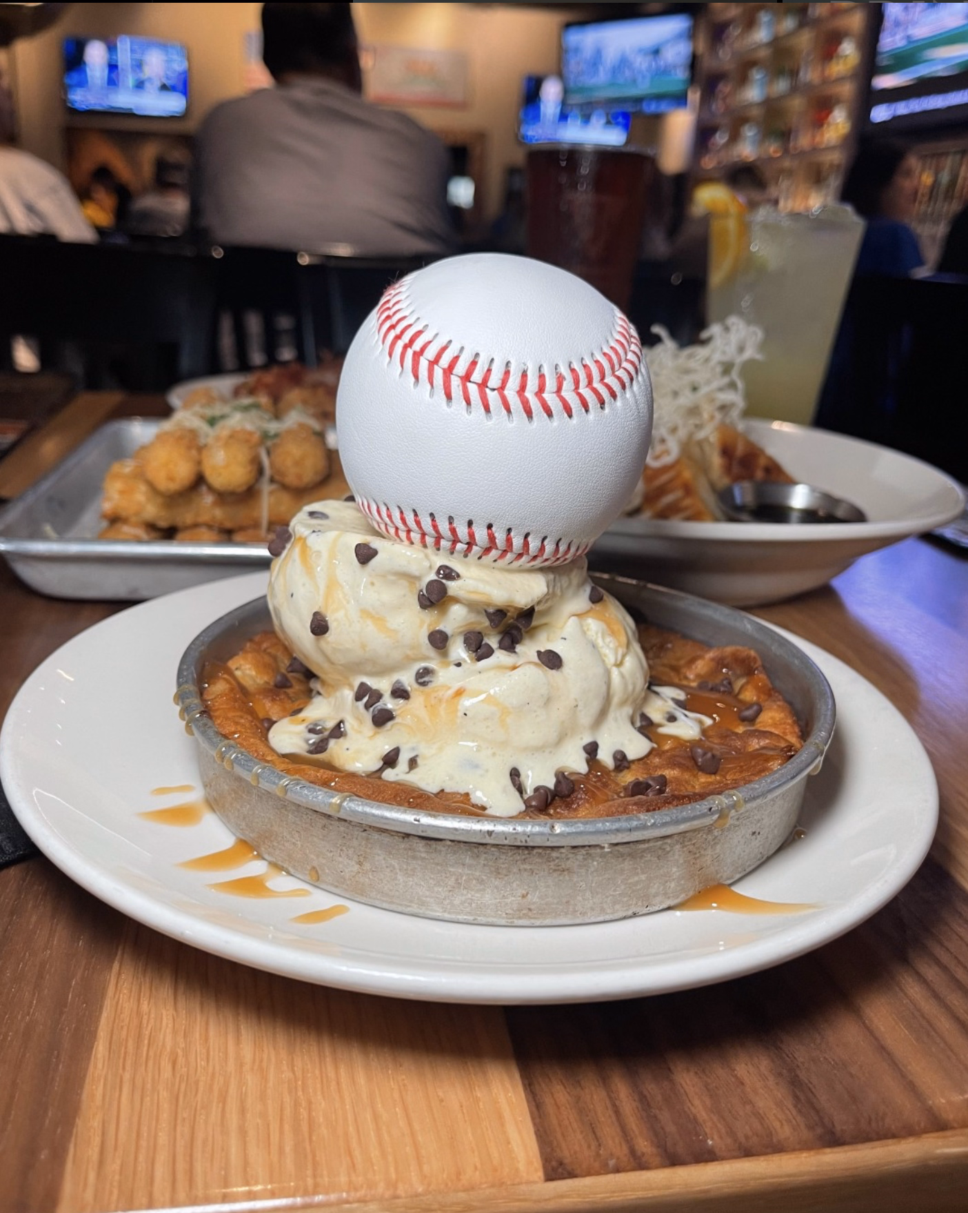 Close-up of BJ’s signature Pizookie, served with vanilla ice cream and a baseball-themed touch.
