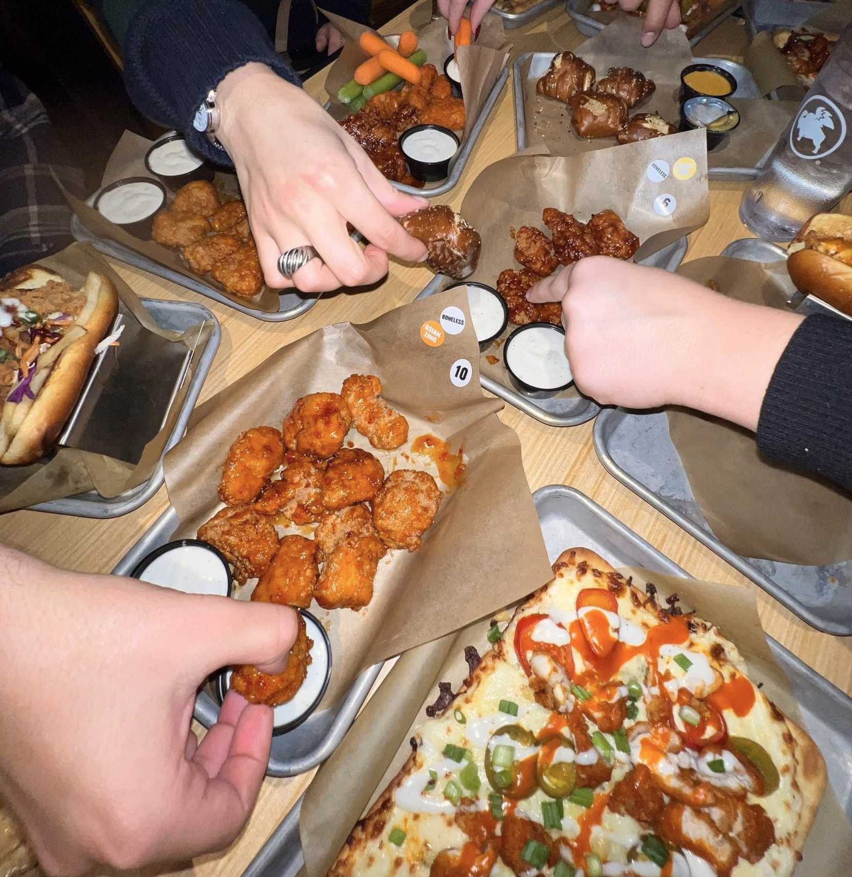 Buffalo Wild Wings appetizer platter with pretzels, mozzarella sticks, chips, and dipping sauces.
