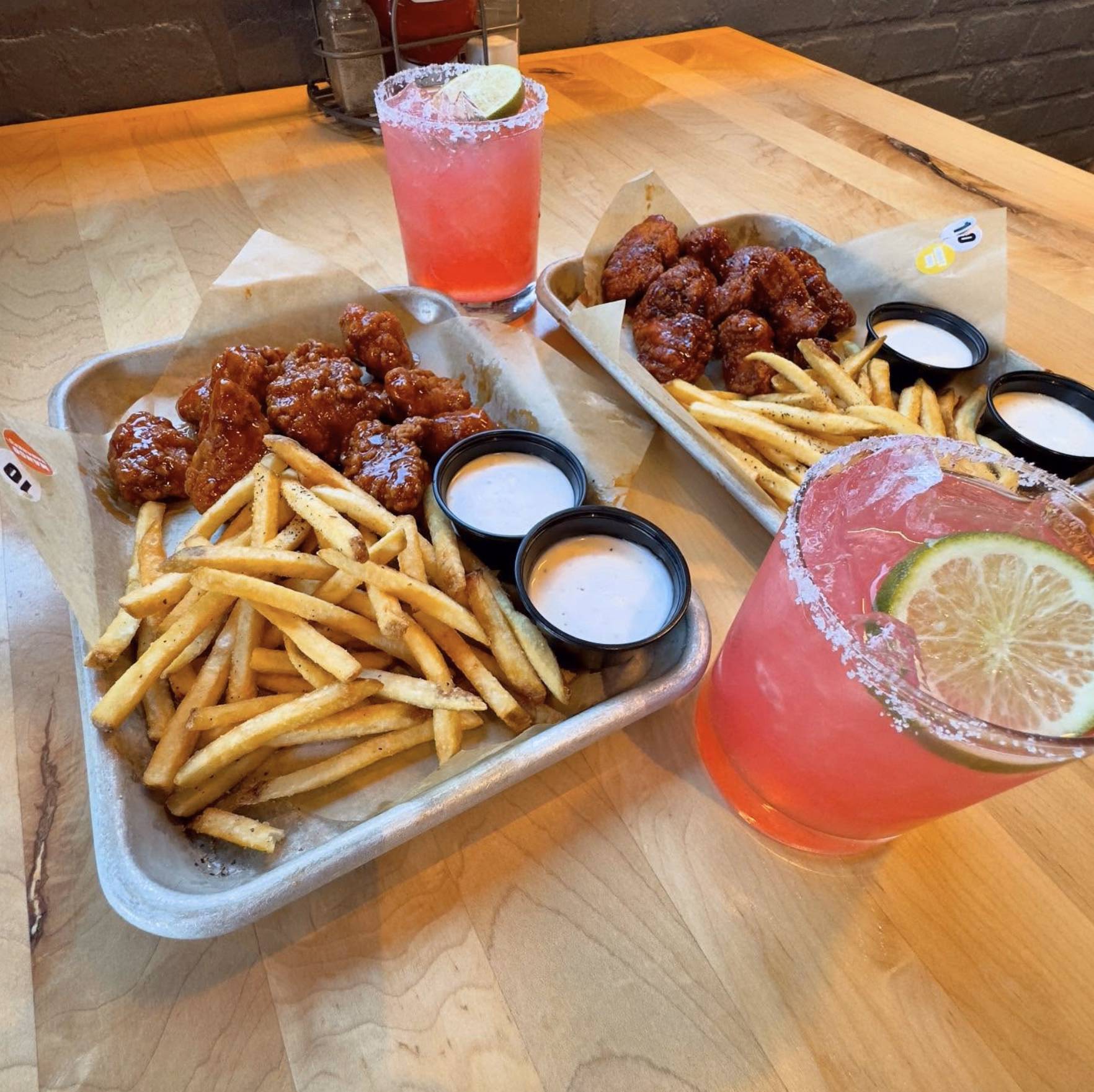 Crispy boneless wings coated in spicy sauce, served with fries, ranch, and margaritas at Buffalo Wild Wings.