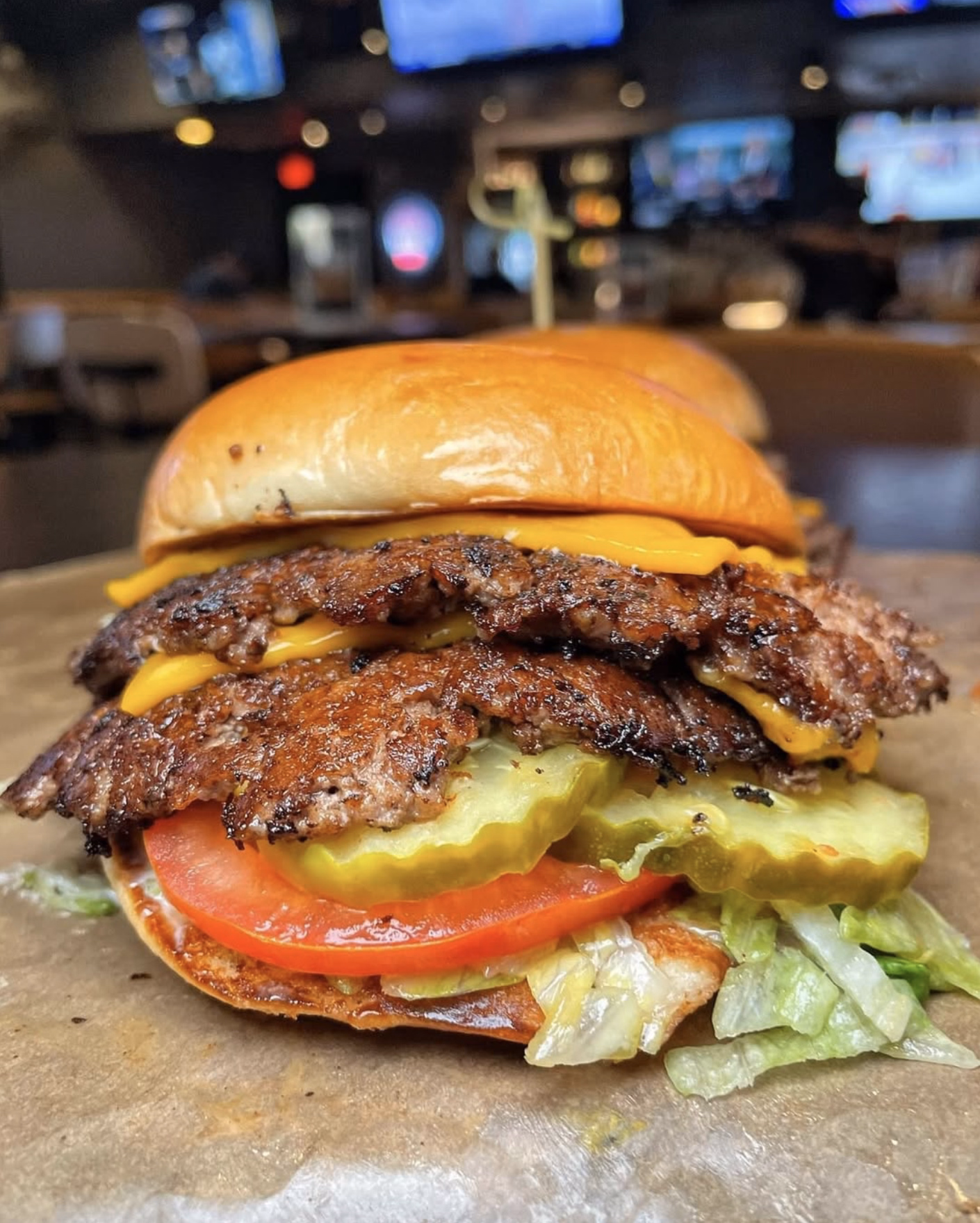 Juicy double cheeseburger with crispy edges, fresh toppings, and soft brioche bun at Buffalo Wild Wings.