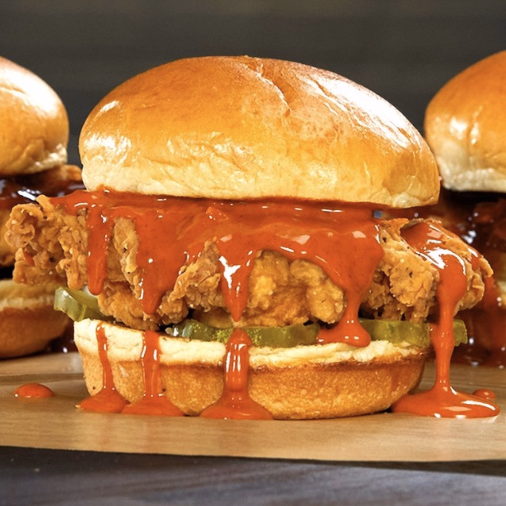 Buffalo Wild Wings crispy fried chicken sandwich smothered in hot sauce and pickles.
