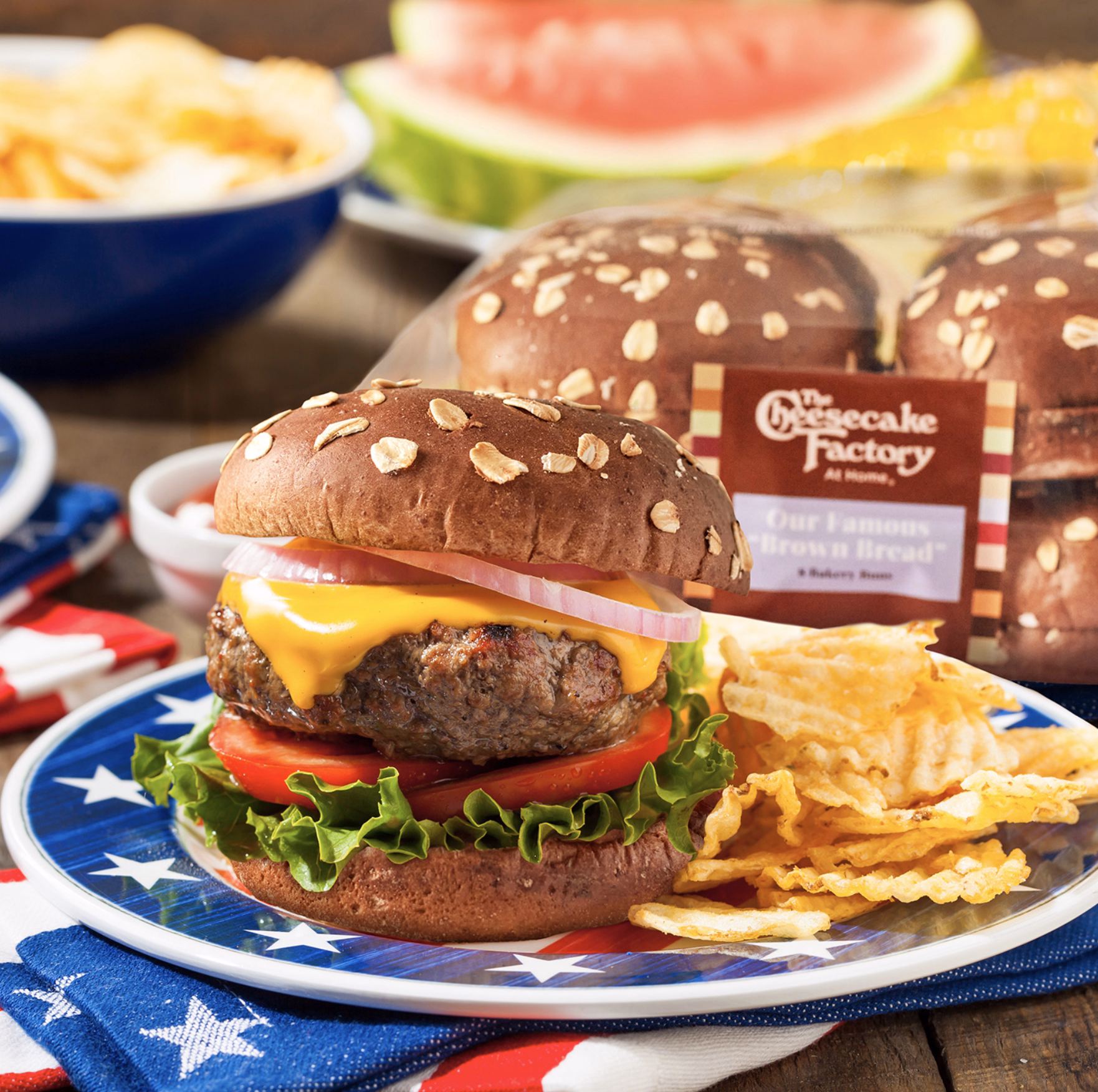 Classic cheeseburger with lettuce, tomato, and onion on hearty brown bread.