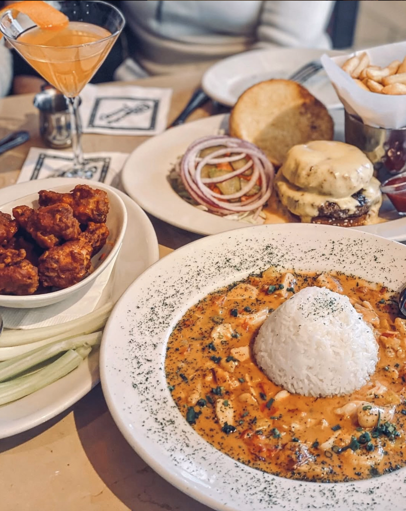 Full table spread with creamy pasta, and buffalo wings.