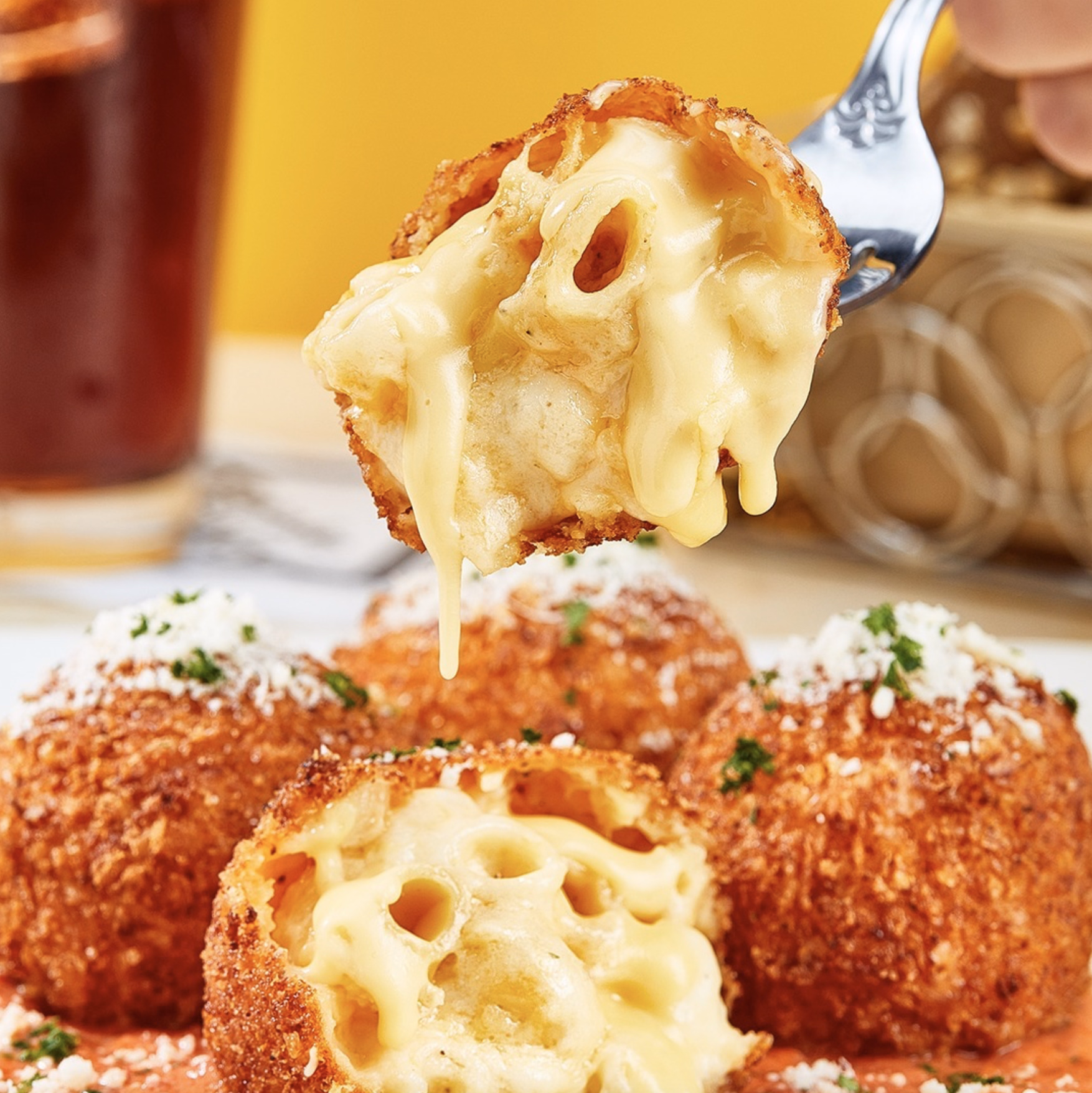 Crispy mac and cheese bites with parmesan and melted center.