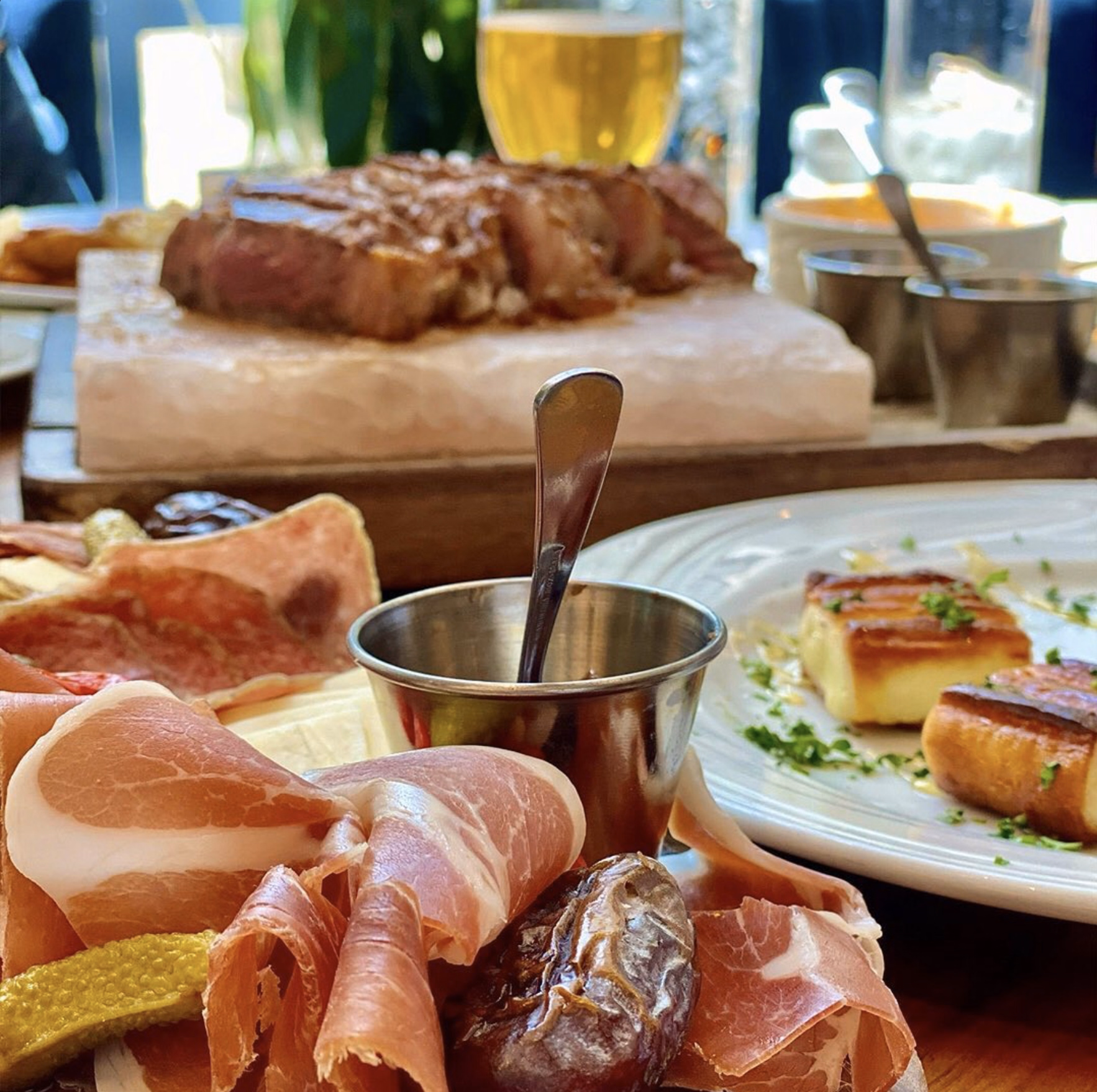 Cured meats, artisan cheeses, and fresh accompaniments served as a refined antipasto platter.