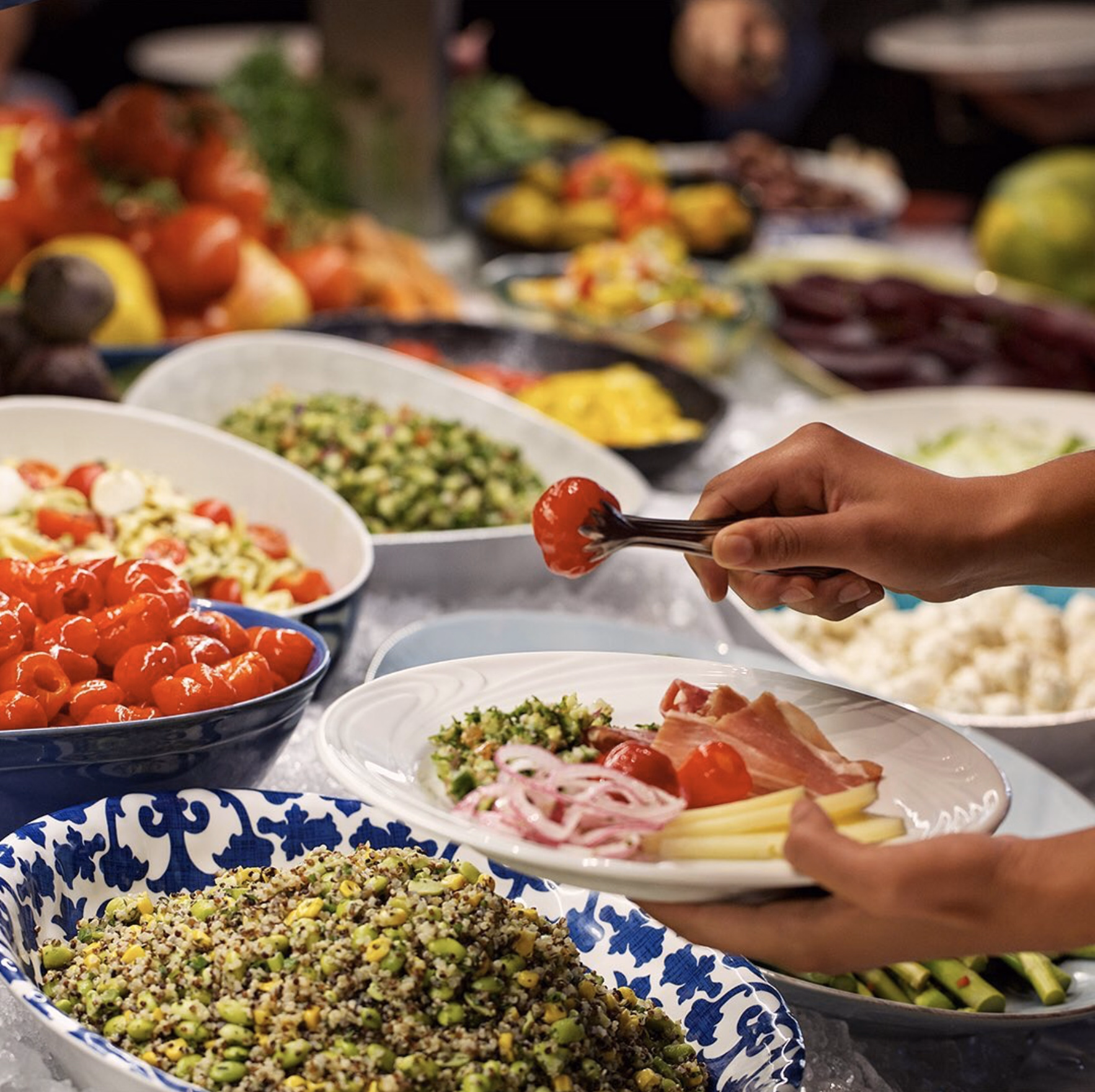 A vibrant buffet of quinoa salad, cherry tomatoes, and fresh greens at Fogo de Chão’s market table.