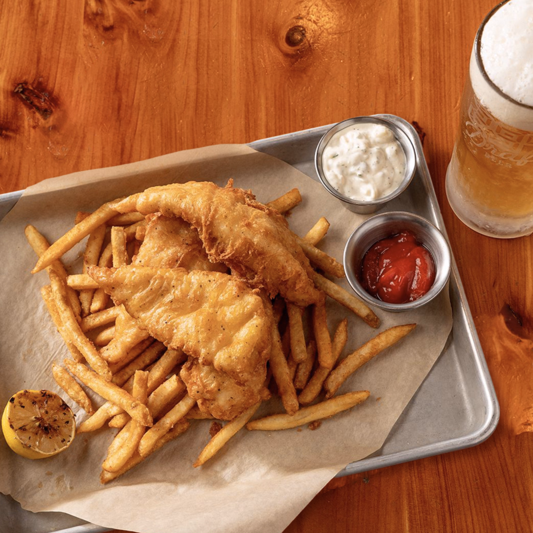 Classic fish and chips basket served with lemon and cold brew.