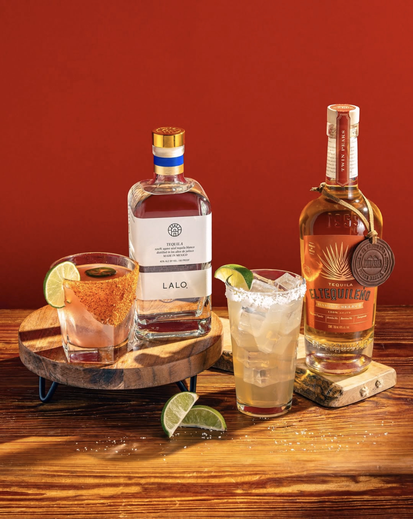 Craft tequila drinks served with lime wedges and salted rims.