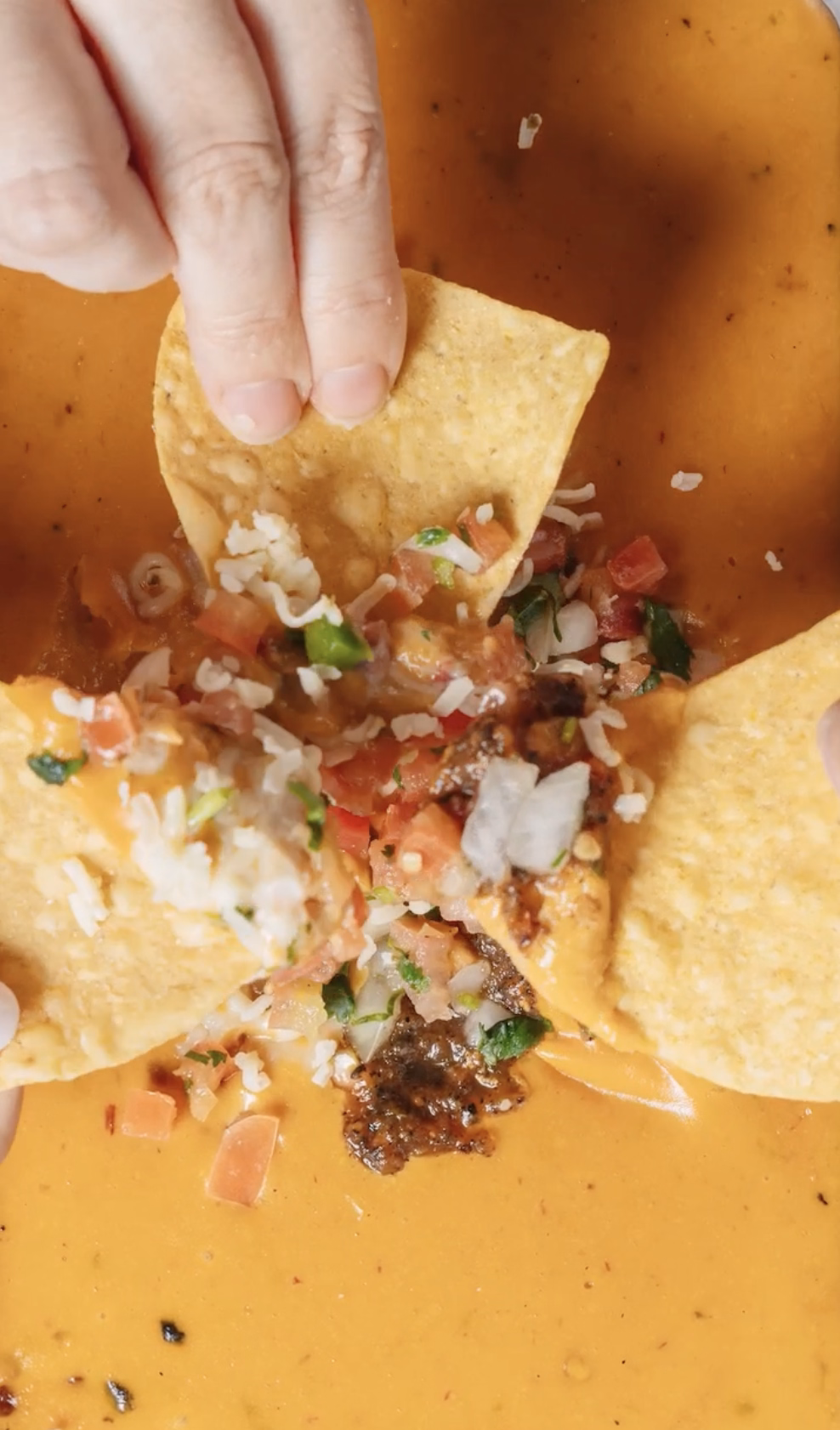 Tortilla chips loaded with queso, pico, and fresh toppings.